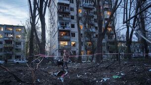 A woman with a dog walks among the rubble of a house damaged after a Russian strike on residential area in Kyiv (Evgeniy Maloletka/AP) A woman with a dog walks among the rubble of a house damaged after a Russian strike on residential area in Kyiv (Evgeniy Maloletka/AP)