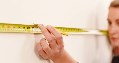 Female worker making wall markings