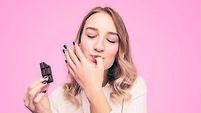 Young woman with chocolate licking finger