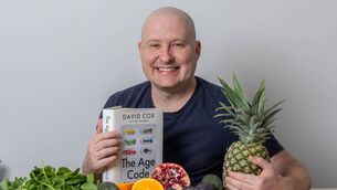 <p>Science writer David Cox with his book The Age Code. Picture: by David McHugh / Brighton Pictures</p>