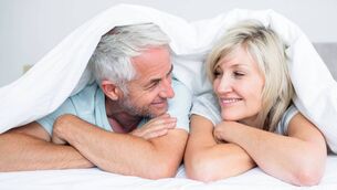 <p>Closeup portrait of a mature couple lying in bed at home</p>