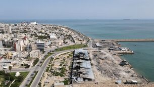 <p>Backdropped by ships in the Strait of Hormuz, damage, according to local witnesses caused by several recent airstrikes during the U.S.-Israel military campaign, is seen on a fishing pier in the port of Qeshm island, Iran, Monday, April 13, 2026. (AP Photo/Asghar Besharati)</p>