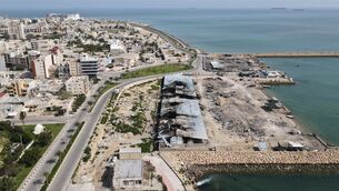 <p>Backdropped by ships in the Strait of Hormuz, damage, according to local witnesses caused by several recent airstrikes during the U.S.-Israel military campaign, is seen on a fishing pier in the port of Qeshm island, Iran, Monday, April 13, 2026. (AP Photo/Asghar Besharati)</p>