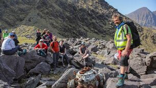 <p>Local MacGillyCuddy's Reeks Guide, John O'Sullivan, guides Wander Wild Outdoor Festival trekkers, to the engine site of the ill-fated 'Skytrain'. Picture: Valerie O'Sullivan.</p>