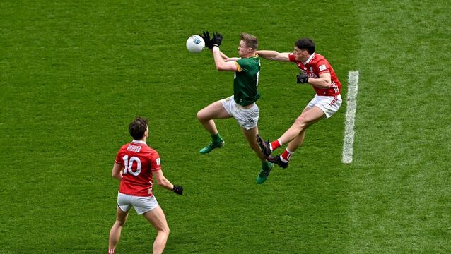 <p>Cian McBride of Meath in action against Colm O'Callaghan of Cork. Pic: Ramsey Cardy/Sportsfile</p>