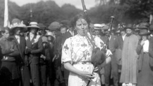 <p>A piper performing at a feis at the Mardyke in Cork in July, 1926. She — and everyone else in the photo — are probably among the millions of people resident in Ireland on April 18 that year recorded in the 1926 census. Picture: Irish Examiner Archive </p>