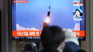 <p>People watch a TV screen showing a news program reporting about North Korea's missile launch at a train station in Seoul, South Korea. Photo: Lee Jin-man</p>