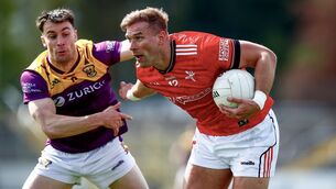 <p>Louth's Conor Grimes in action against Wexford's Pairic Hughes. Pic: Inpho</p>