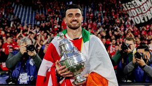 <p>ALL WRAPPED UP: Ireland's Troy Parrott, draped in a tricolour, celeberates AZ Alkmaar's win in the Europjackpot KNVB Beker (Dutch Cup final) against NEC Nijmegen at the Stadium Feijenoord in Rotterdam. Pic: Marcel Bonte/Soccrates/Getty Images</p>