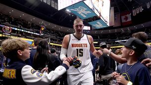 <p>SAINT NIC: Nikola Jokic leaves the floor after their win against the Minnesota Timberwolves. Pic: Matthew Stockman/Getty Images.</p>