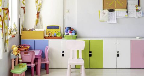 Kindergarten Classroom With Table and Colorful Chairs
