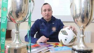 <p>Barry Ryan pictured with Munster and All-Ireland schools cups</p>