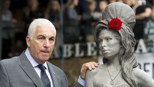 <p>Mitch Winehouse, father of the late Amy Winehouse, next to a statue of his daughter following its unveiling on what would have been the singer's 31st birthday, at the Stables Market, Camden Town, London.</p>