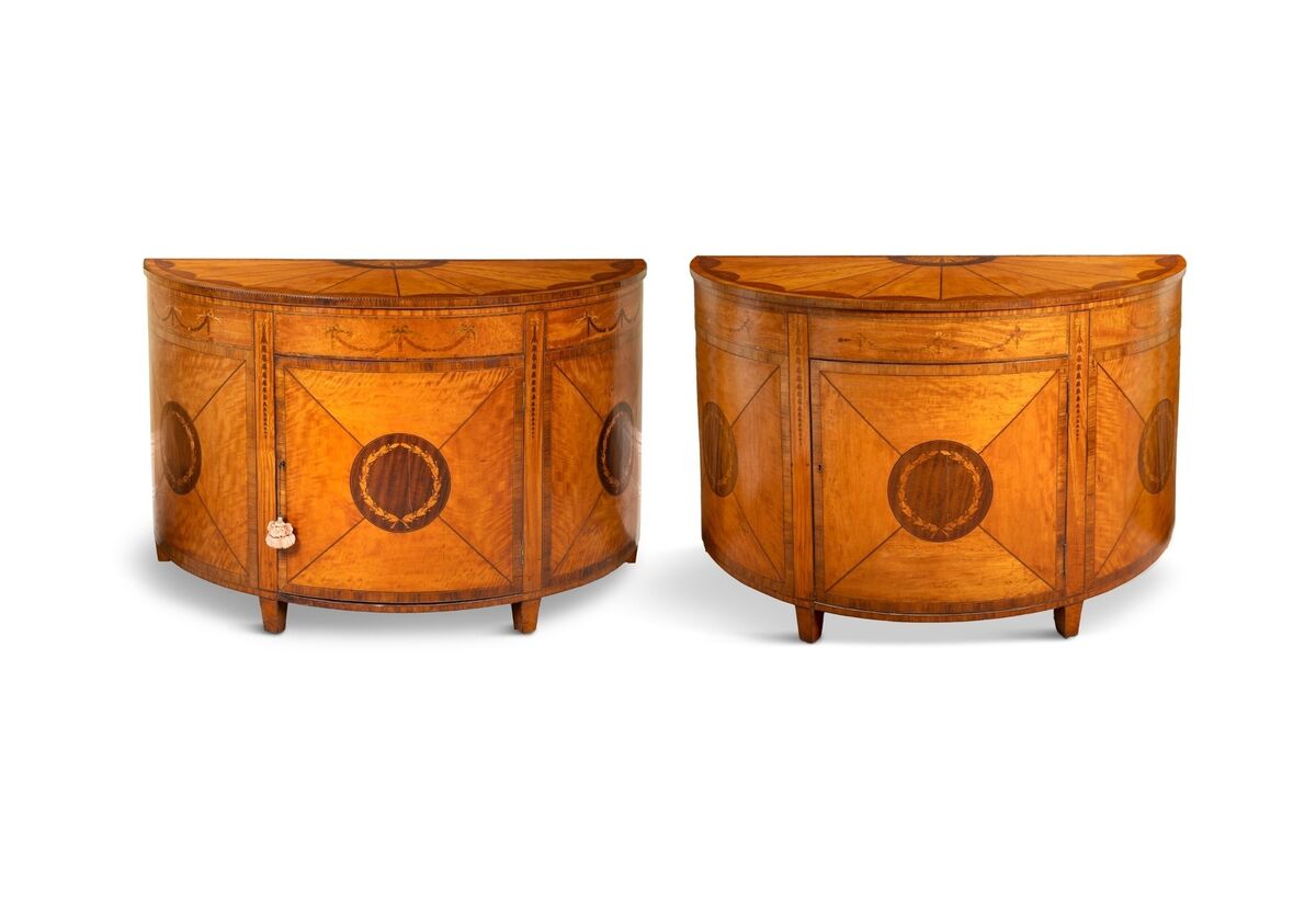 A pair of George III commodes in the manner of William Moore at Adam's.