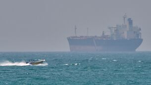 <p>A boat sails past a tanker anchored on the Strait of Hormuz off the coast Qeshm island, Iran, Saturday, April 18, 2026. (AP Photo/Asghar Besharati)</p>