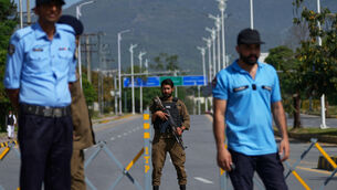 Police officers stand guard at a checkpoint ahead of the second round of negotiations between the US and Iran, in Islamabad, Pakistan (Anjum Naveed/AP)