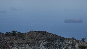 <p>Tankers and bulk carriers anchored in the Strait of Hormuz on Saturday (AP Photo)</p>