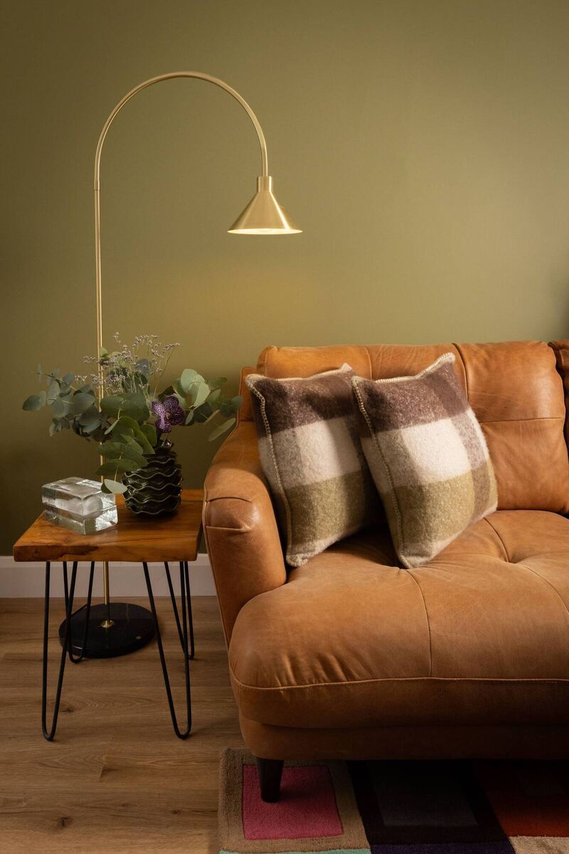 Mid-century accents and forest green feature in Emily Quinn's living space. 