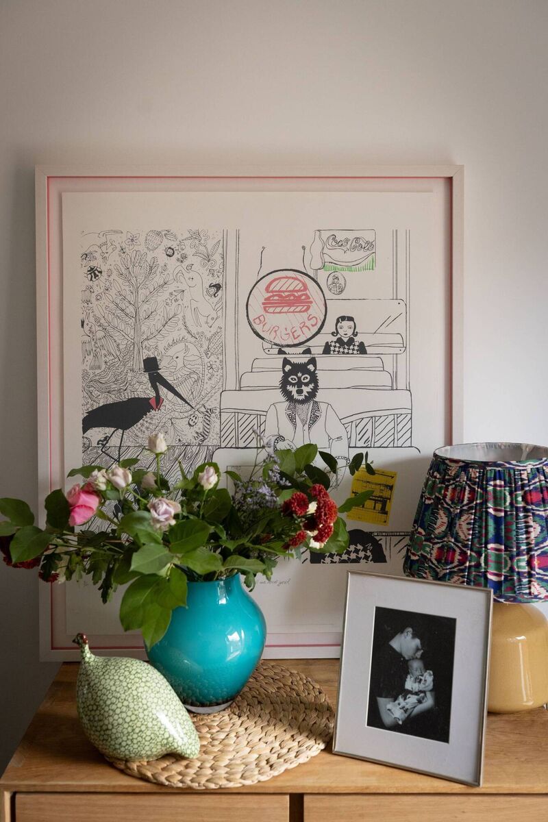 A framed print by the art duo Electronic Sheep is a visual anchor and a conversation starter as soon as you walk in the front door. Is the print’s subject a person with a wolf mask or a human-wolf hybrid. 