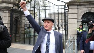 <p>Michael Healy-Rae salutes protesters after resigning from Government last week. Picture: Stephen Collins/Collins</p>