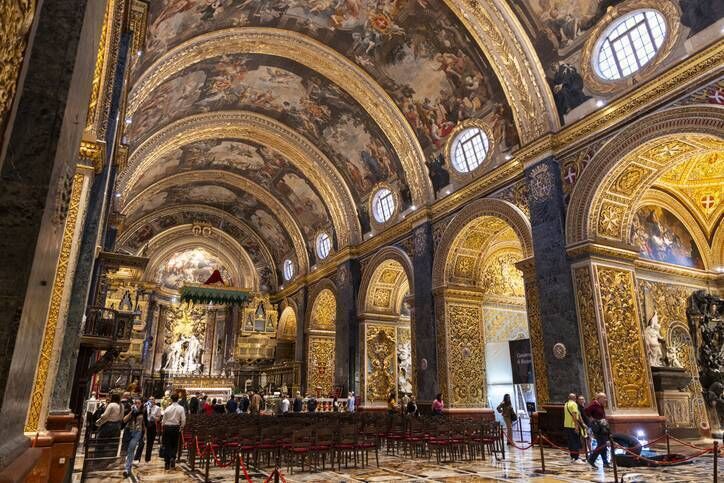 The ornate interior of St. John's Co-Cathedral in Valletta, Malta, featuring intricate baroque design and rich artwork