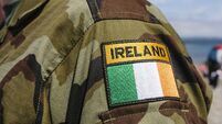 Shoulder patch of a soldier from the Irish Army on camouflaged uniform.