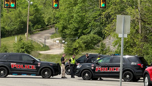 Police block a road near a chemical plant where a leak occurred (John Raby/AP)