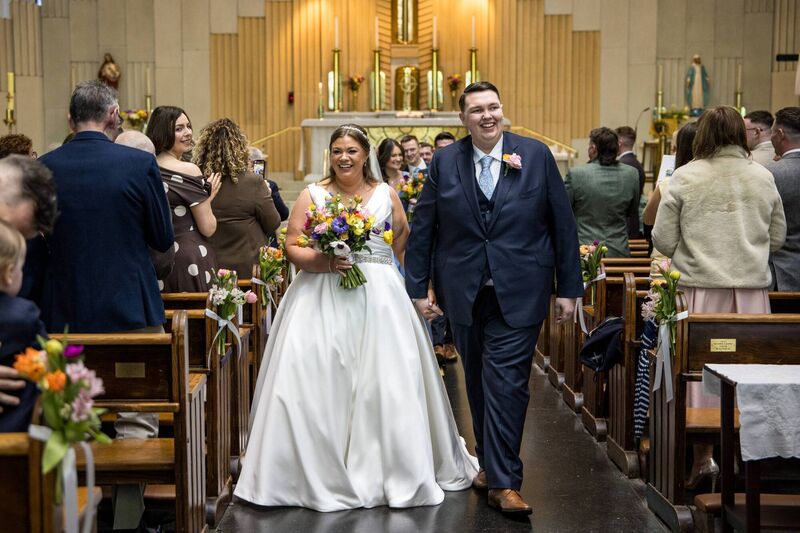 Stephanie Cotter and Ryan Ahern walking back down the aisle. Pictures: Laura and Benny Photography 