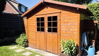 Wooden garden shed in a summer
