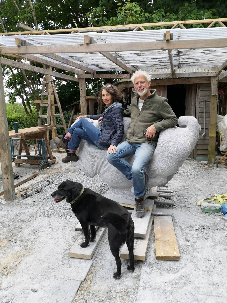 Johanna Connor and Michael Quane on one of his sculptures, 'Piginning'. Also pictured is their dog Coco.