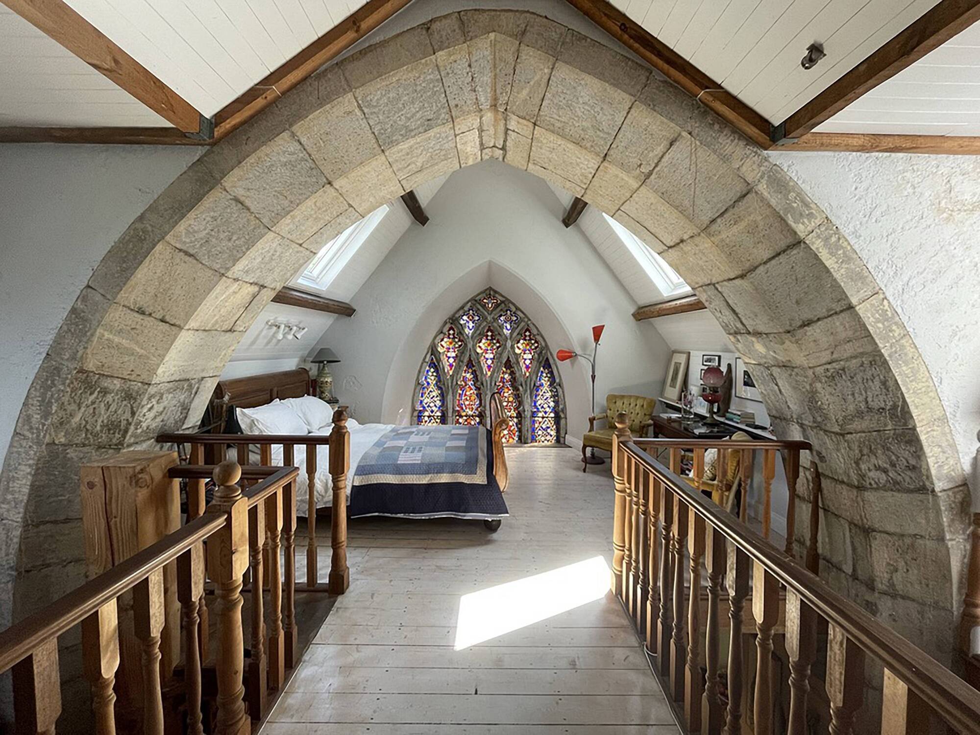 Morning sunlight floods the bedroom, located at the altar end of the building, above the kitchen.