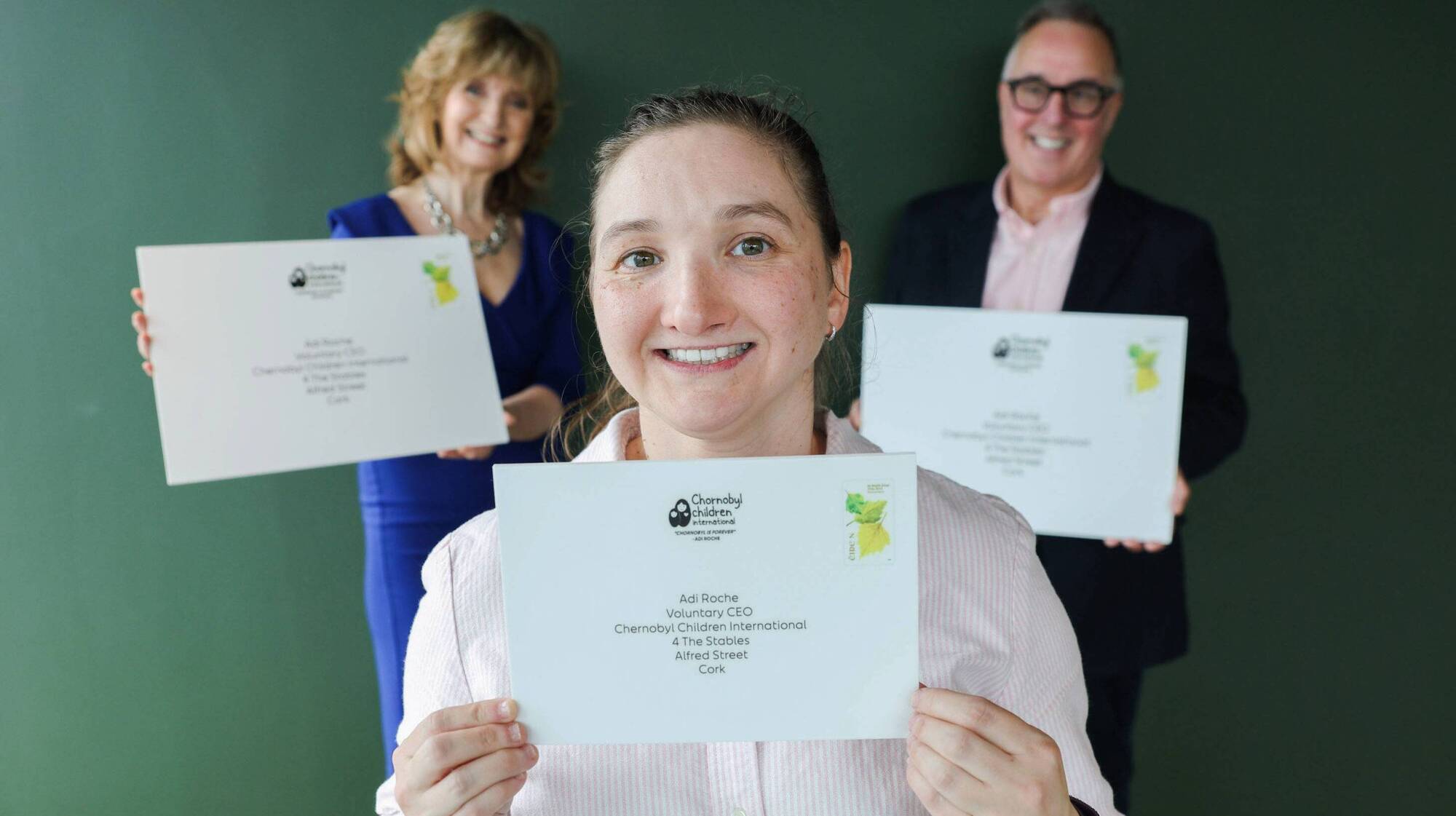 At the unveiling of a special postmark for the 40th anniversary of the Chornobyl nuclear disaster in Ukraine is survivor, Raisa Carolan (centre) who was adopted by an Irish family as a young girl, with Adi Roche (left), voluntary CEO of Chornobyl Children International and David McRedmond (right), CEO of An Post. Photo: Maxwells