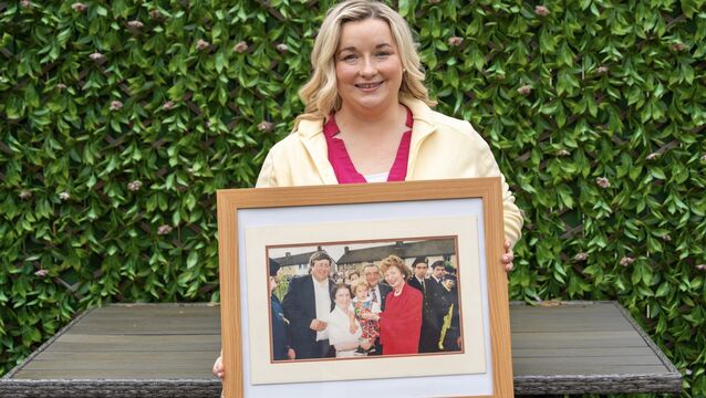 <p>Anna Gabriel with a framed picture of a time when as a child she and her parents met former President of Ireland Mary Robinson during her visit to Bandon in 1996. Picture: Noel Sweeney</p>