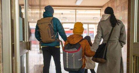Happy family on train station