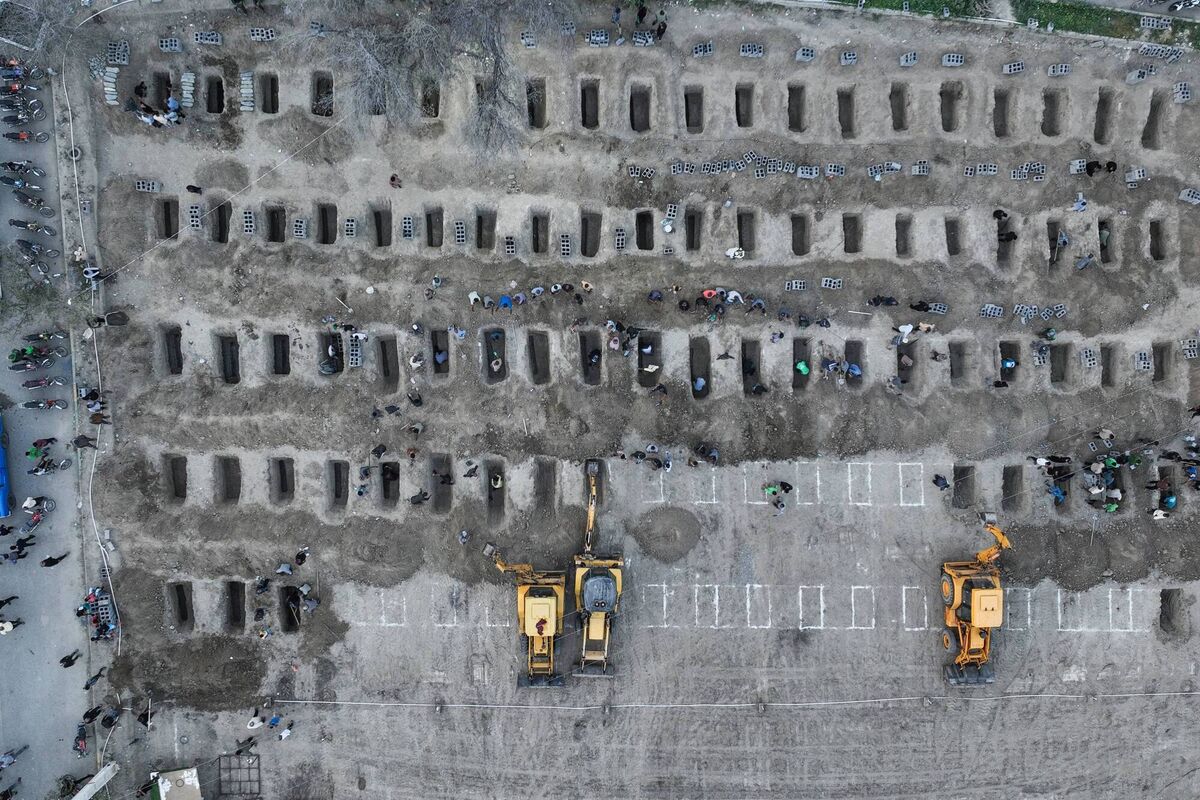In this aerial handout picture released by the Iranian Press Center, mourners dig graves during the funeral for children killed in a reported strike on a primary school in Iran's Hormozgan province in Minab on March 3, 2026. Picture: Iranian Press Center