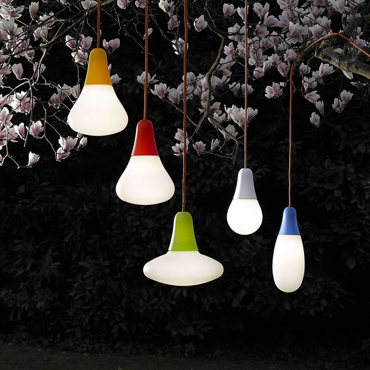 Hanging lights flown at various heights in flocked groups, anchor and define space. Always check the weather rating of your outdoor pieces. Meeting our obsession with globes and curves this season, these (mains) Martinelli Luce Ciulifruli (just adore the orange cable) include an external plug. They're €144, Lights.ie.
