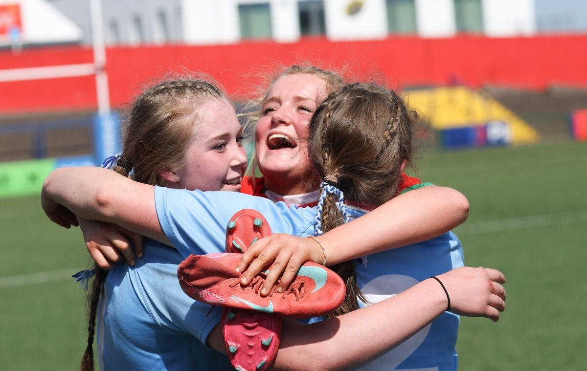 Sacred Heart Clonakilty's Molly Deegan congratulates Beibhinn Brennan and Aoife O'Mahony after winning the final. Pic: ©INPHO/Tom Maher.