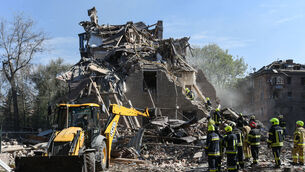 Rescue workers clear the rubble of a residential building destroyed by a Russian strike, in Dnipro, Ukraine, on Saturday (Mykola Synelnykov/AP)