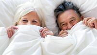 Senior couple lying in bed together