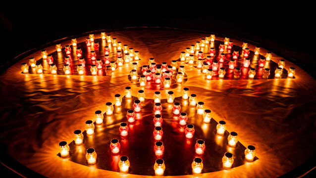 Candles were arranged into a radiation hazard symbol to mark the anniversary (Dan Bashakov/AP)