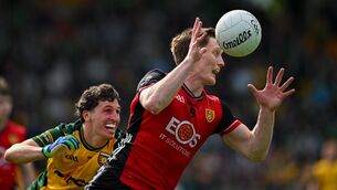 <p>Odhran Murdock of Down in action against Finnbarr Roarty of Donegal. Pic: Ramsey Cardy/Sportsfile</p>