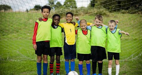 Junior football team standing together
