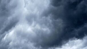 <p>A Caution Sign in Front of dramatic Storm Clouds Warning of Approaching Storms.</p>