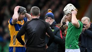 <p>GET READY: Tony Kelly and Cian Lynch fix their helmets before they clash. Pic: Brendan Moran/Sportsfile.</p>