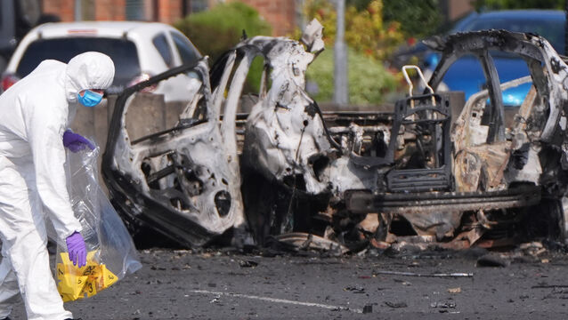 <p>Forensic investigators at the scene in Dunmurry (Niall Carson/PA)</p>