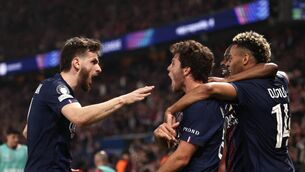 <p>MAN O WAR: Paris Saint-Germain's Portuguese midfielder Joao Neves celebrates with Khvicha Kvaratskhelia (L) and Desire Doue (R) after scoring his side's second goal in a Champions League semi-final first leg thriller against Paris Saint-Germain at Parc des Princes. Pic: Franck Fife, Getty Images)</p>