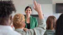 Female teacher giving presentation to university students