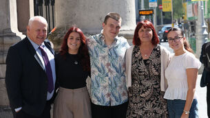 <p>Eoin Danaher, Raheen, Co Limerick, with his family Lauren, Kay, and Rebecca, alongside solicitor Joseph Cuthbert, left, outside the Four Courts as the High Court approved the €9.75m settlement against the HSE. Picture: Collins Courts</p>