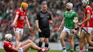 <p>Tim O'Mahony of Cork on the ground as referee James Owens approaches before he issues Cian Lynch of Limerick a red card. Pic: Ray McManus/Sportsfile</p>