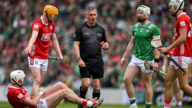 <p>Tim O'Mahony of Cork on the ground as referee James Owens approaches before he issues Cian Lynch of Limerick a red card. Pic: Ray McManus/Sportsfile</p>